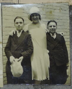 Photo showing Donna Darling with two young men, certainly brothers, possibly twins.