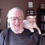 Photo of Don Taylor with his cat, Isan, on his shoulder.