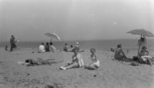 Photo of sun bathers on beach, circa 1940.