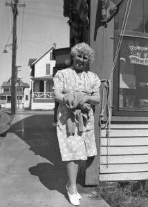 Photo of a woman by a store.