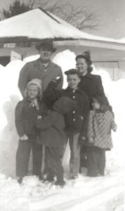 Photo of the Newton Curtis Family, winter clothes, snowbanks around.