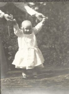 Photo of Pauline with her second son, Frank, learning to walk, circa 1909.