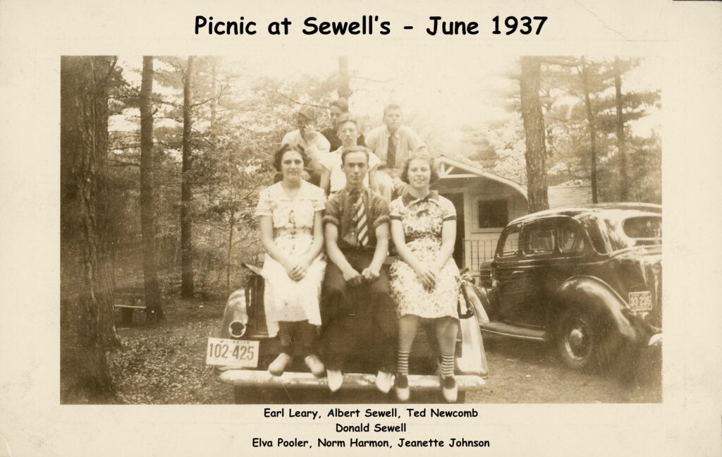 Photo of seven teenagers on a car in the 1930s. 