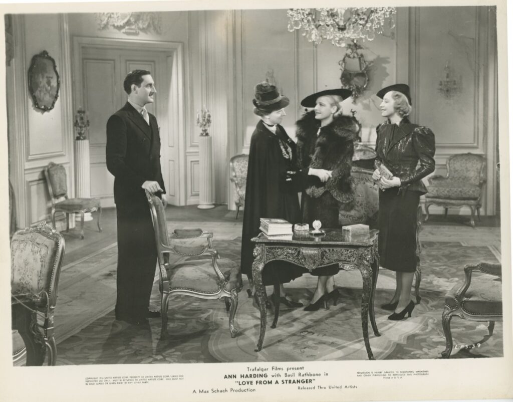 [Photo — left to right: a man, and three women, dressed for the outdoors, gathered in an elegant drawing room]