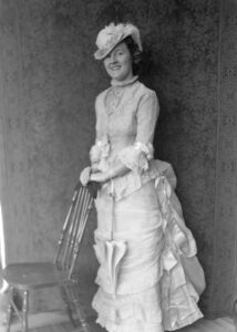 Photo of Sylvia Rowell, circa 1935 standing in a very fancy dress.