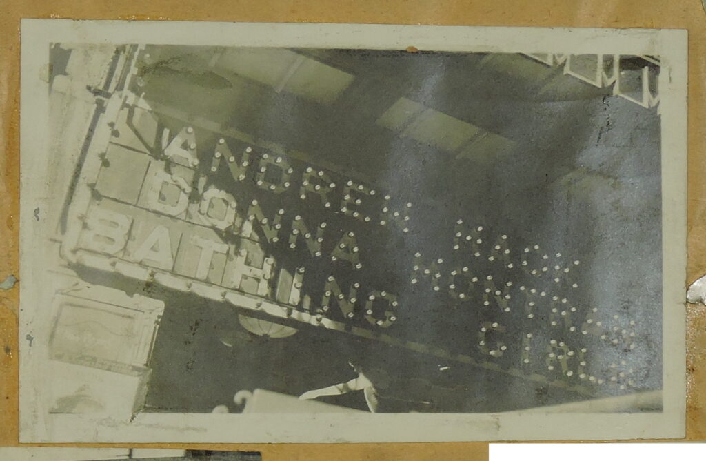 Photo of an attractor board showing "Andrew Mack, Donna Montran, & Bathing Girls."