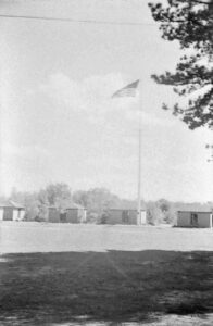 Photo of a summer camp with a tall flagpole.