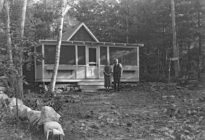 Photo of a camp with an older couple in front.
