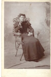 Photo of a woman sitting in a chair circa 1895