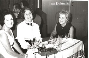 Photo of three women at a dining table on a ship.