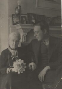 Photo of an elderly woman and a younger man. circa 1940s. 