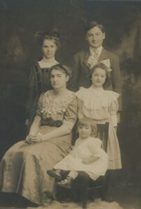 Vintage photo of five children from ages 1 to 17.