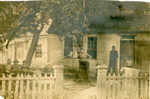 Photo of 6 people outside a hold house.