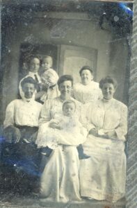 Tintype photo of 5 women and two children.