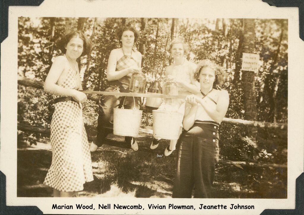 Four young women with a water carrier.
