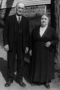 A man and a woman in their 60s standing outside.