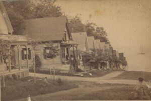 Photo of many similar cottages leading down towards the ocean.