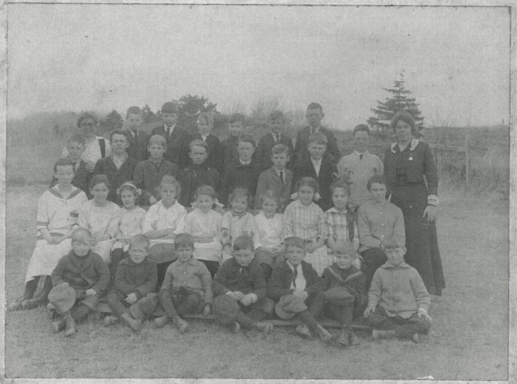 This is a formal outdoor school photograph from the early 20th century, likely taken around 1915–1920. It appears to be a copy of the photograph and not an original photo.